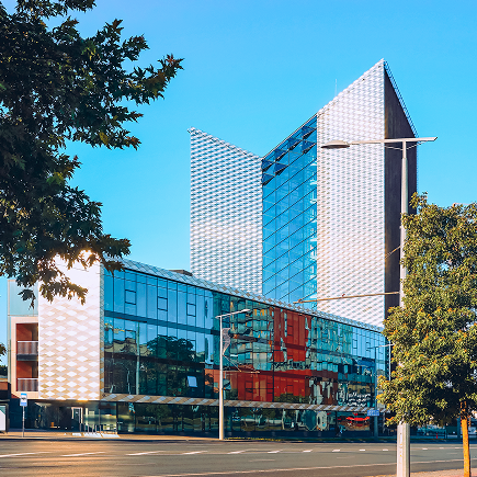eu-street-view-modern-steel-glass-skyscraper-building-architecture-reflecting-blue-sky 1